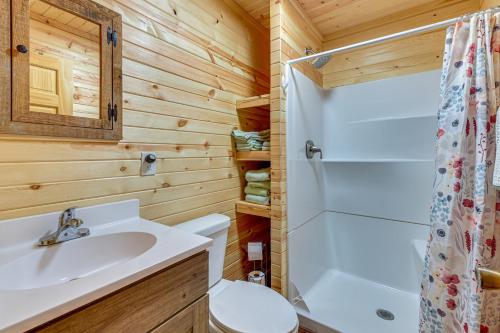 a bathroom with a sink and a toilet and a shower at Greenbrier River On-Site! Modern-Rustic Log Cabin in Marlinton