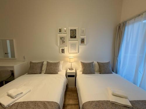 two beds sitting next to each other in a room at OUCHI HOTEL Hiroshima Station in Hiroshima