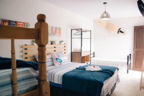 a bedroom with a bed with blue sheets and toys on it at Pousada do Mestre in Pontal do Paraná