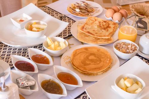 a table topped with pancakes and other breakfast foods at Diament Luxury Camp in Merzouga