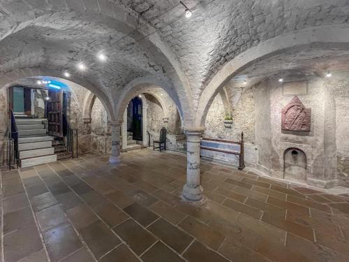 a large room with stone walls and a staircase in a building at The Merchants Penthouse - Uk50408 in Canterbury