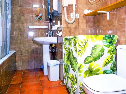 a bathroom with a toilet and a sink with a shower curtain at Ski Apartment in Sierra Nevada in Sierra Nevada