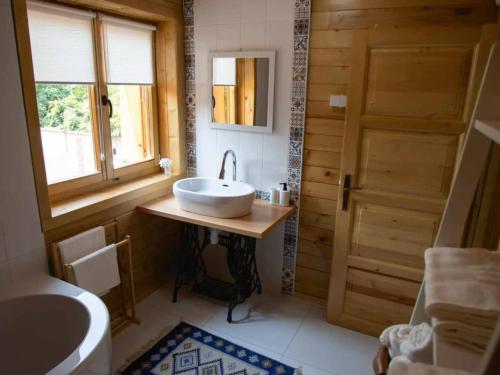 a bathroom with a white sink and a window at Four bedroom villa in Vukovar
