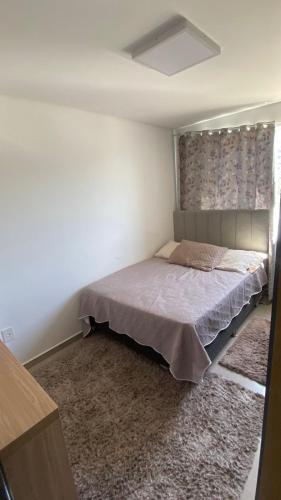 a bedroom with a bed in a room at Ap sol nascente in Itapema