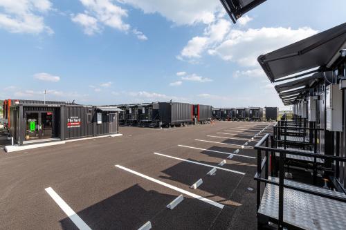 an empty parking lot with a bunch of terminals at HOTEL R9 The Yard Shibushi in Nakazono