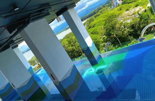 a view of the water from a balcony of a resort at Bay Suites Home By Sea 海的家 1016 in Kota Kinabalu