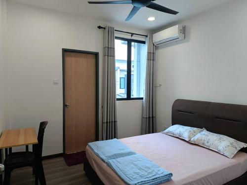 a bedroom with a bed and a ceiling fan at V Love Homestay in Kota Samarahan
