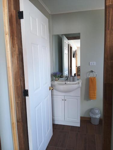 a bathroom with a white sink and a mirror at Villa Lucita in Manquel