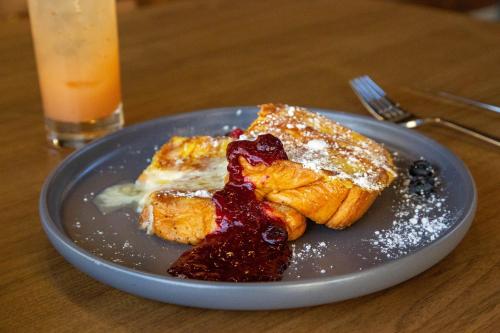 a blue plate with french toast and blueberry sauce at Bay Valley Resort & Conference Center in Bay City