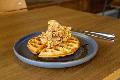 a plate of waffles with a piece of cereal on it at Bay Valley Resort & Conference Center in Bay City