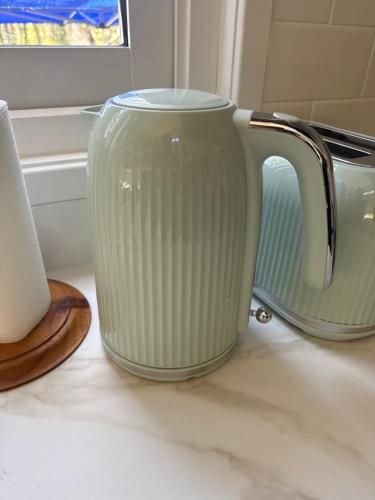 a green vase sitting on top of a counter at Big Tiny Medlow in Medlow Bath