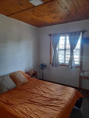 a bedroom with a bed and a window at LA ARBOLADA in Mar del Plata