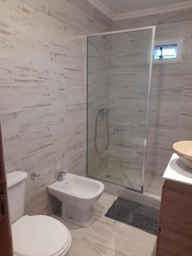 a bathroom with a shower and a toilet and a sink at LA ARBOLADA in Mar del Plata
