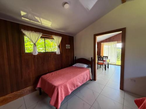 a bedroom with a bed and a window and a table at Campo Azul #2 - Monteverde in Monteverde Costa Rica