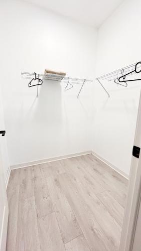 a room with white walls and a wooden floor at Yonge Finch Subway Modern Room with En Suite Bathroom in Toronto