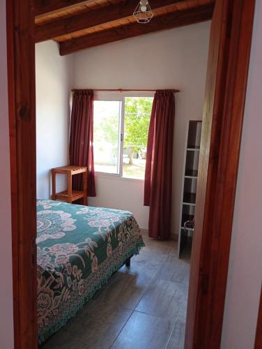 a bedroom with a bed and a window at Departamento Rosales Nro 2 in Valeria del Mar