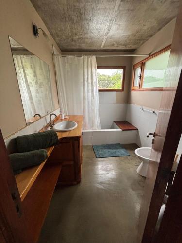 a bathroom with a sink and a toilet and a window at Casa Maloneli in Ostende