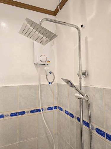 a shower with a shower head in a bathroom at GLAJJ Residences - Tubod Iligan City in San Miguel