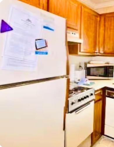 a refrigerator with papers on it in a kitchen at Beech Mountain Ski Suite in Beech Mountain