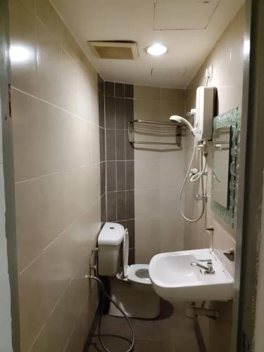a bathroom with a toilet and a sink at J Hotel Bukit Bintang in Kuala Lumpur
