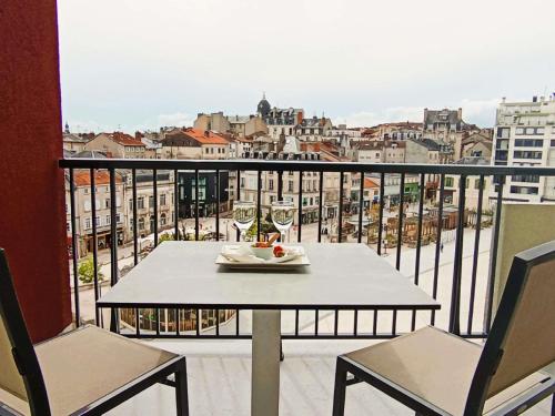 a table and chairs on a balcony with a view at Mercure Limoges Centre in Limoges