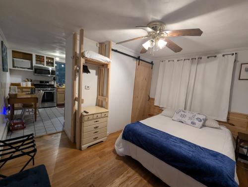 a bedroom with a bed and a ceiling fan at Quiet, Convenient Studio Andover Merrimack Valley - Long Stays Only in Andover