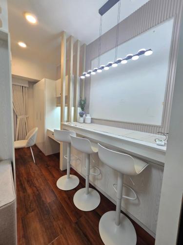 a kitchen with a white counter and stools at Condo Hotel Walking Abreeza Mall and Near SM Lanang in Davao City