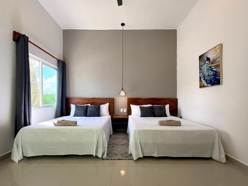 Postel nebo postele na pokoji v ubytování Vica Mayan Guest House