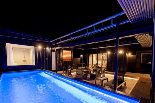 a house with a swimming pool at night at 淡路島 Villa Paddle - Self Check-In Only in Sumoto