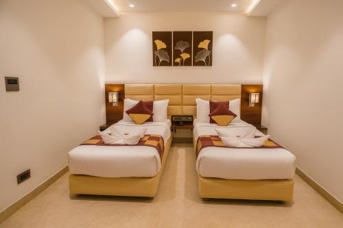 a hotel room with two beds in a room at HOTEL TEN SQUARE - 5 Minutes from The Taj Mahal in Agra