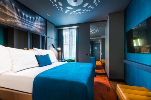 a hotel room with a bed and a tv at Pestana CR7 Lisboa in Lisbon