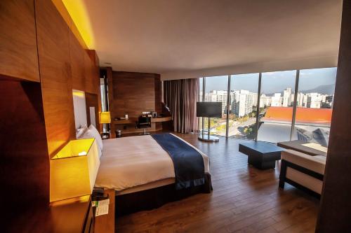 a hotel room with a bed and a view of a city at Holiday Inn Gwangju by IHG in Gwangju