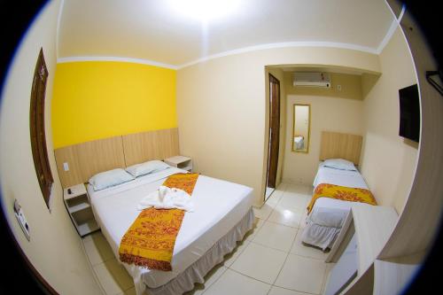 Una cama o camas en una habitación de Hotel Pousada Latitude