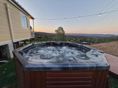 a hot tub in the backyard of a house at Country Cottage of Yesteryear 