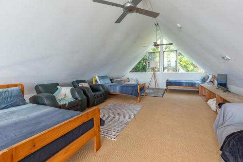 ein Wohnzimmer mit 2 Betten und einem Deckenventilator in der Unterkunft The Shack in Seal Rocks