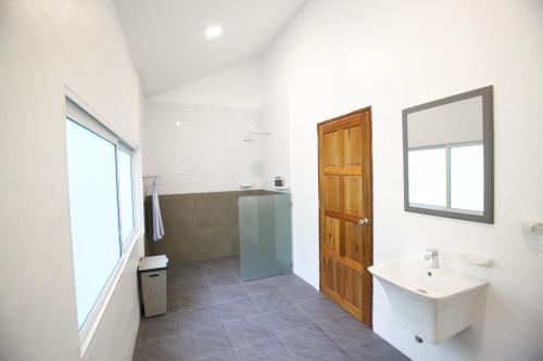 a bathroom with a sink and a mirror at Tropical Garden Luxury Villa, Koh Phangan in Koh Phangan