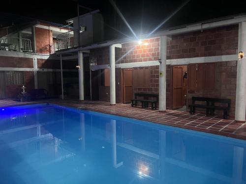 a large swimming pool in a building at night at Villa Lolita in Palmaseca