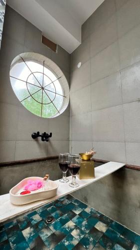a bathroom with two glasses of wine on a counter at Casa Nauka in Colva