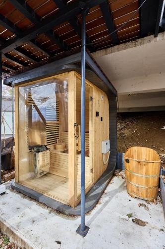 a wooden building with a window on the side at 富士山を見ながらサウナBBQ The No10 MtFuji Forest House in Yamanakako