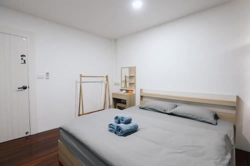 a bedroom with a bed with a blue teddy bear on it at Peaceful 2BR Home Walk to Halal Street Food in Hat Yai