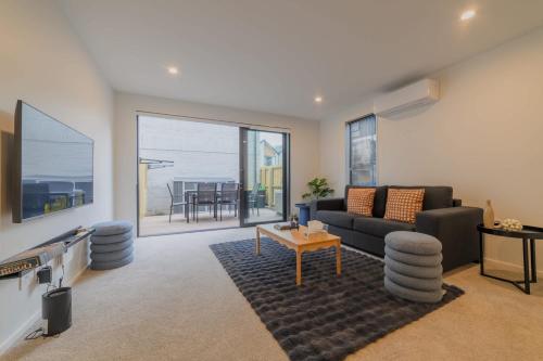 a living room with a couch and a table at Gloucester Escape Modern 2BR with Outdoor Space in Linwood