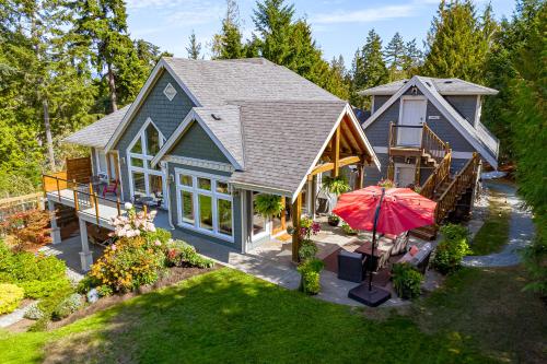 an aerial view of a house with an umbrella at Shawnigan Suite B & B in Shawnigan Lake