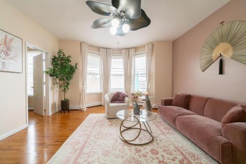 a living room with a couch and a ceiling fan at The Boulevard Stay! 25 mins to NYC! Spacious 2BR! in Harrison