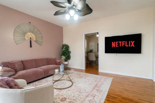 a living room with a couch and a netflix sign at The Boulevard Stay! 25 mins to NYC! Spacious 2BR! in Harrison