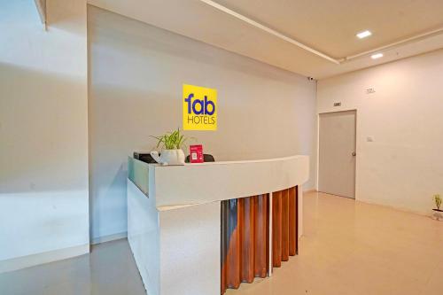 Una oficina con mostrador de recepción con letrero de Ako Floors en FabHotel Stay In, en Vadodara