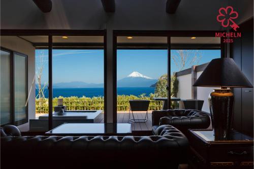 a living room with a view of a mountain at Fugaku Gunjo in Izu