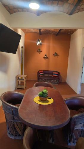 a table with a plant on it in a room at Casita Paraiso Escondido in La Peñita de Jaltemba