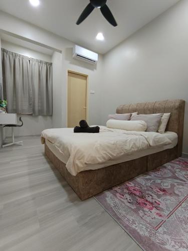 a bedroom with a large bed and a ceiling fan at De Suria Homestay Jitra- 3BR with 4 Aircons in Jitra