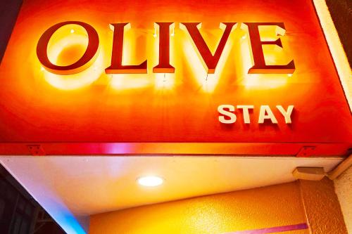 a sign for a drug shop with the words olive stay at OLIVE Stay in Fukuoka