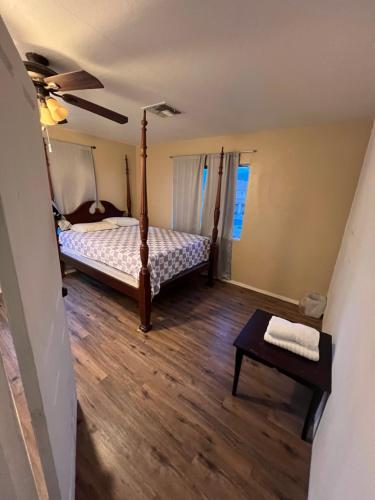 a bedroom with a bed and a wooden floor at West Phoenix Value Room 2 Bennet in Phoenix